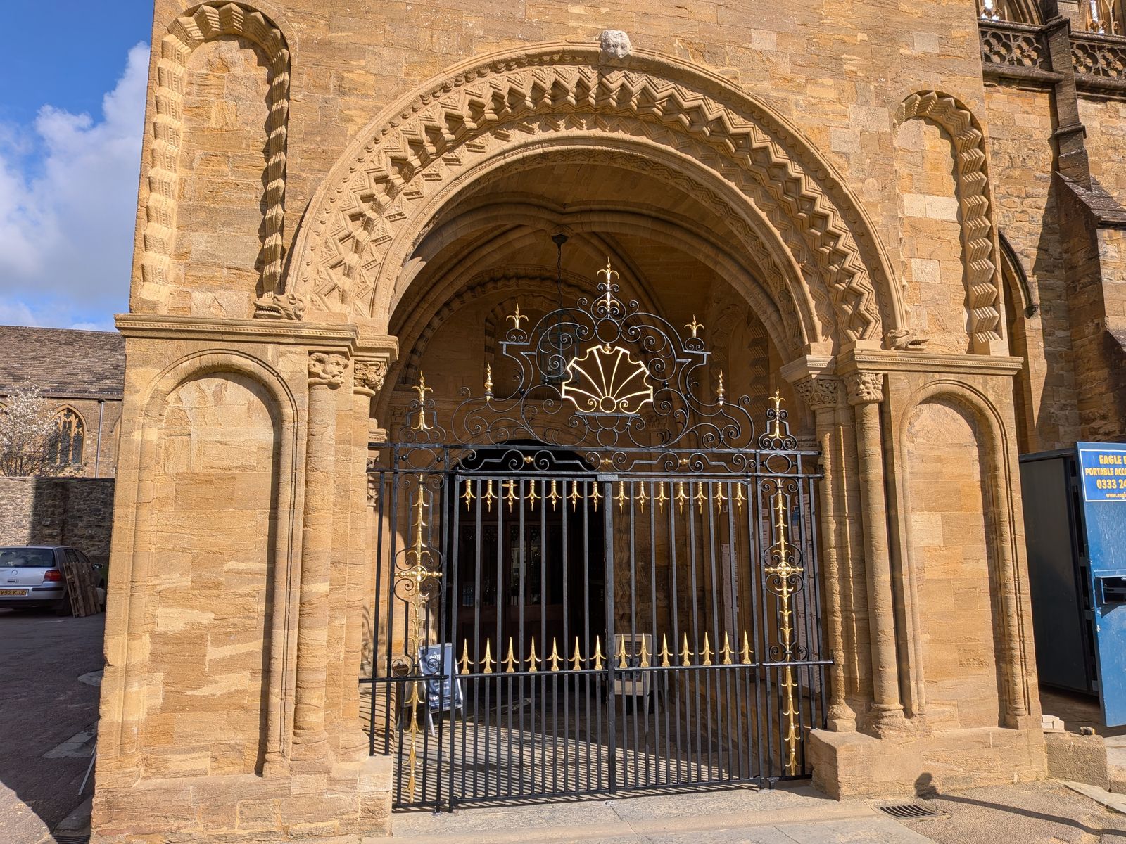 The Norman south porch at Sherborne Abbey with its restored gilded gates